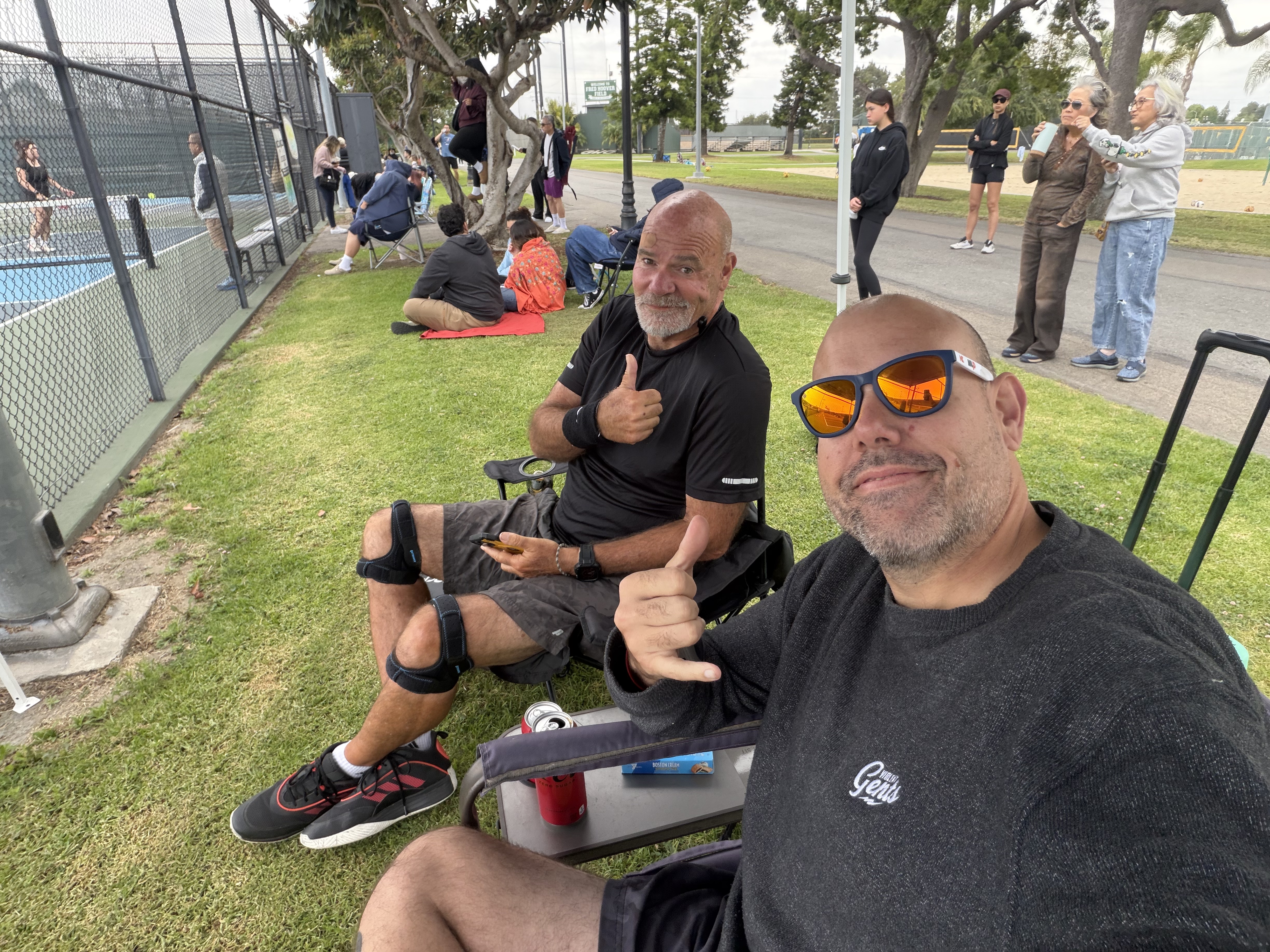 Tim and Paul Baker courtside at a pickleball tournament